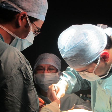 A surgical team performing an operation on a brain tumour patient