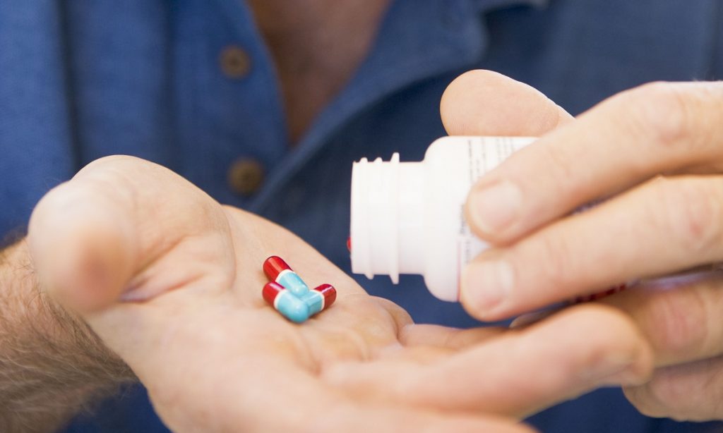 Pills being tipped into palm