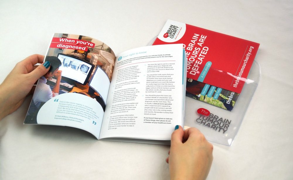 Person reading The Brain Tumour Charity Information Pack, which is full of useful information to help you cope after a brain tumour diagnosis.