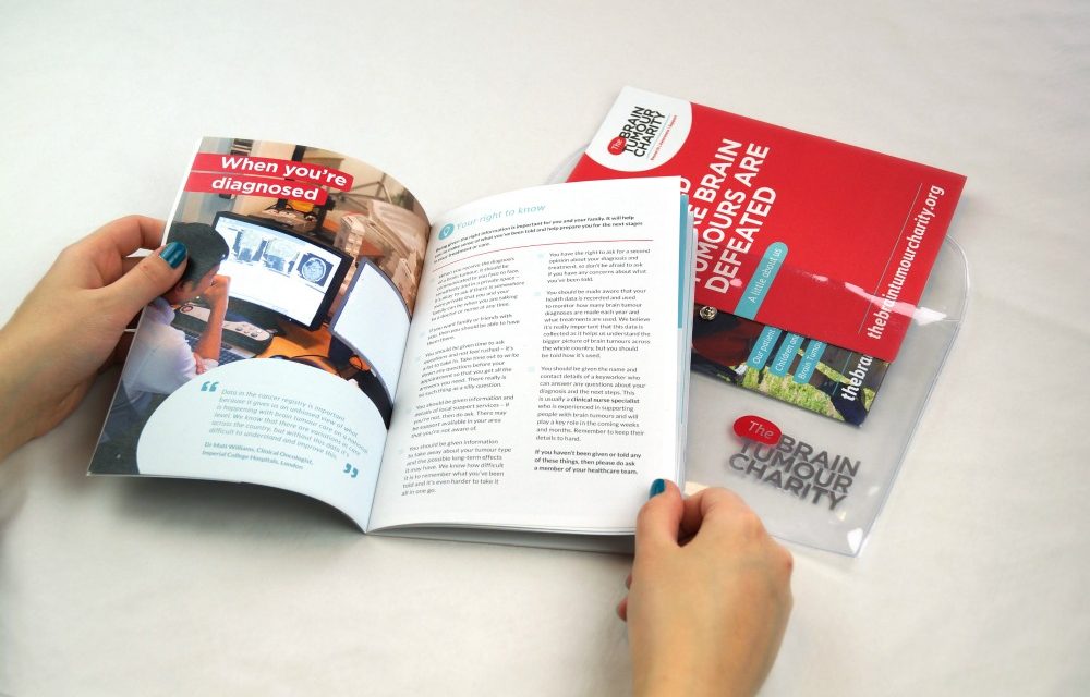 Person reading The Brain Tumour Charity Information Pack, which is full of useful information to help you cope after a brain tumour diagnosis.