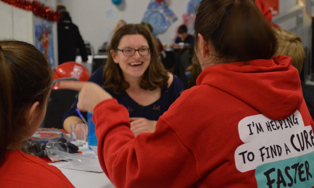 Women from The Brain Tumour Charity sitting around a table