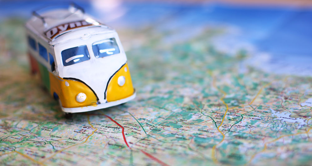 Model VW van on map indicating a direction of travel across a country 