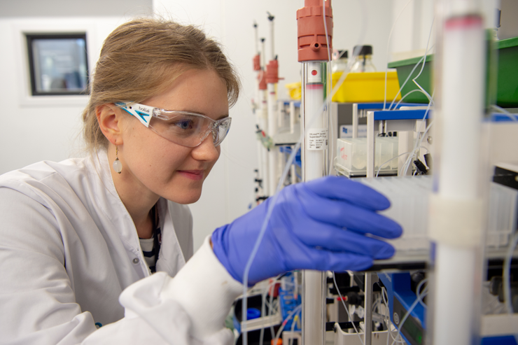 A woman in a lab coat conducting research.