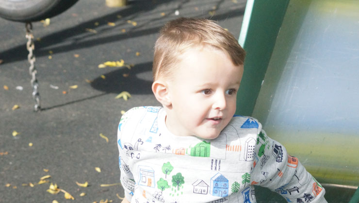 a child plays on a slide in a playground