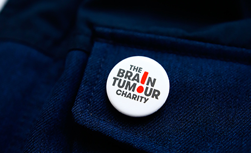 Brain Tumour Charity pin attached to a blue pocket 