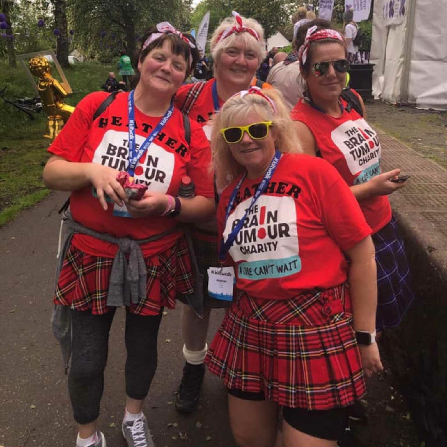 Four women in kilts taking part in the Kiltwalk charity walk