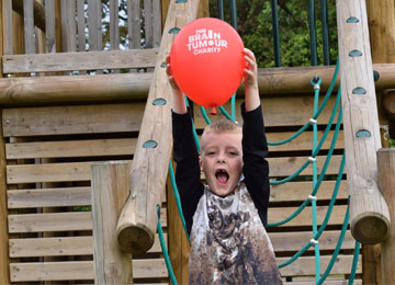 Noah (6) diagnosed with a rare, low-grade brain tumour. He is playing with a brain tumour charity balloon.