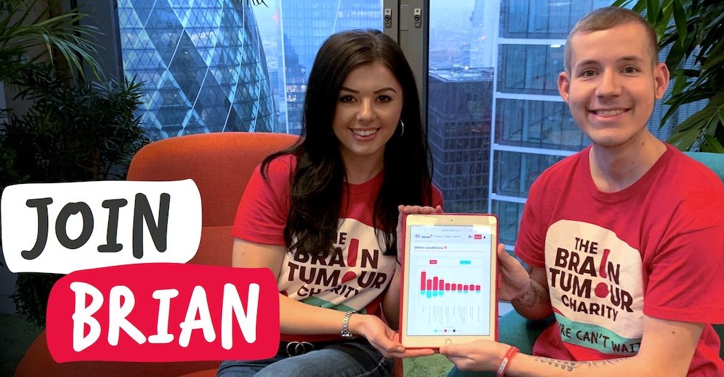 two young supporters of The Brain Tumour Charity holding a tablet showing the BRIAN app - an app designed to help those affected by brain tumours