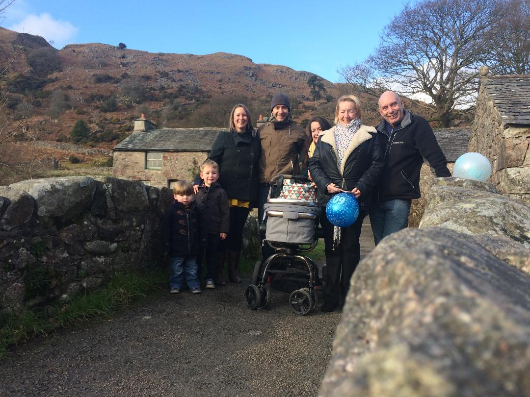 A family stood together on a bridge in the Lake District.