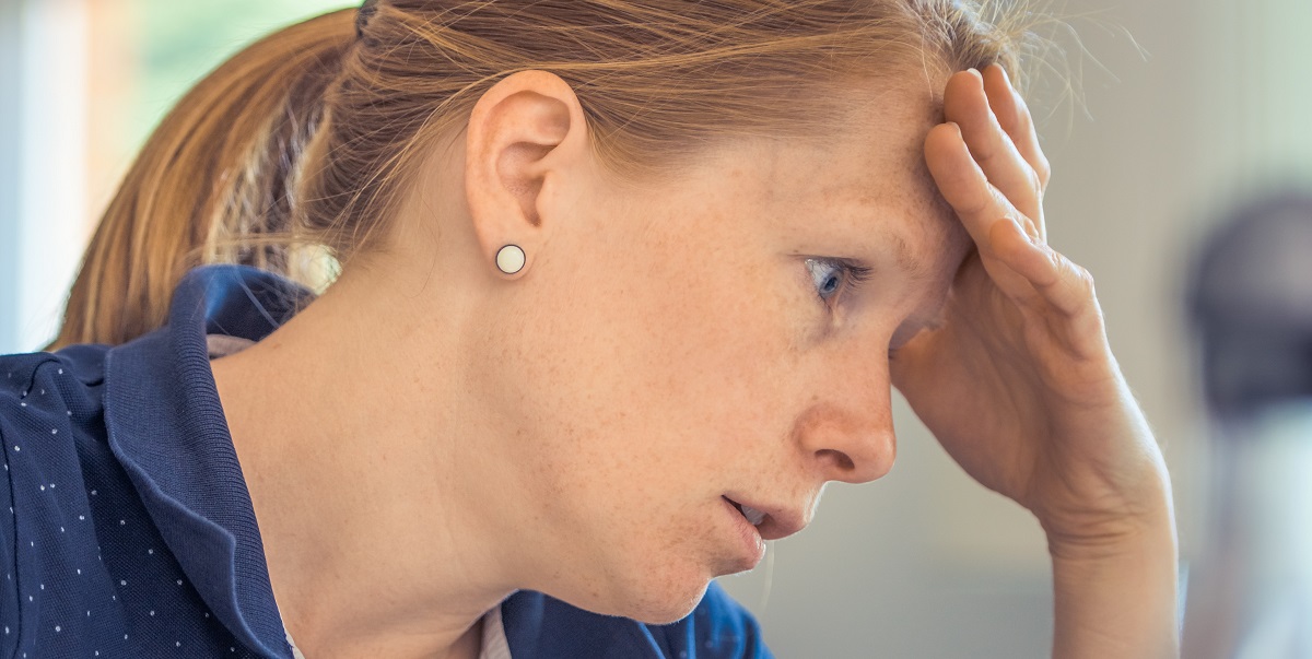 woman with hand on her head experiencing a brain tumour headache