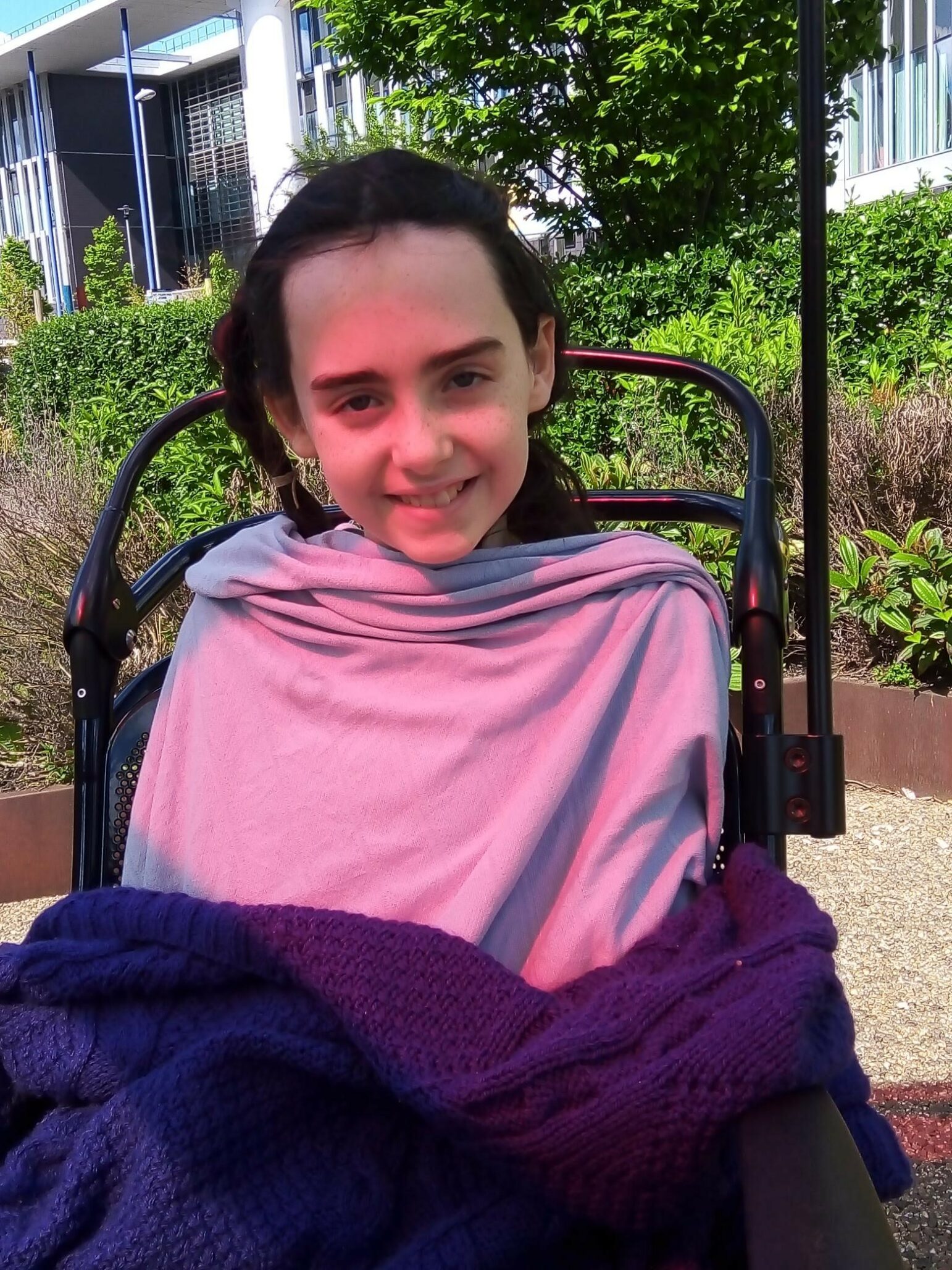 Ramona in a chair in the hospital garden after surgery