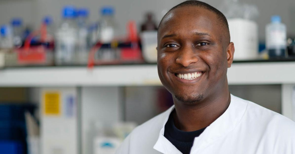 Dr Ola Rominiyi in a white lab coat in a laboratory