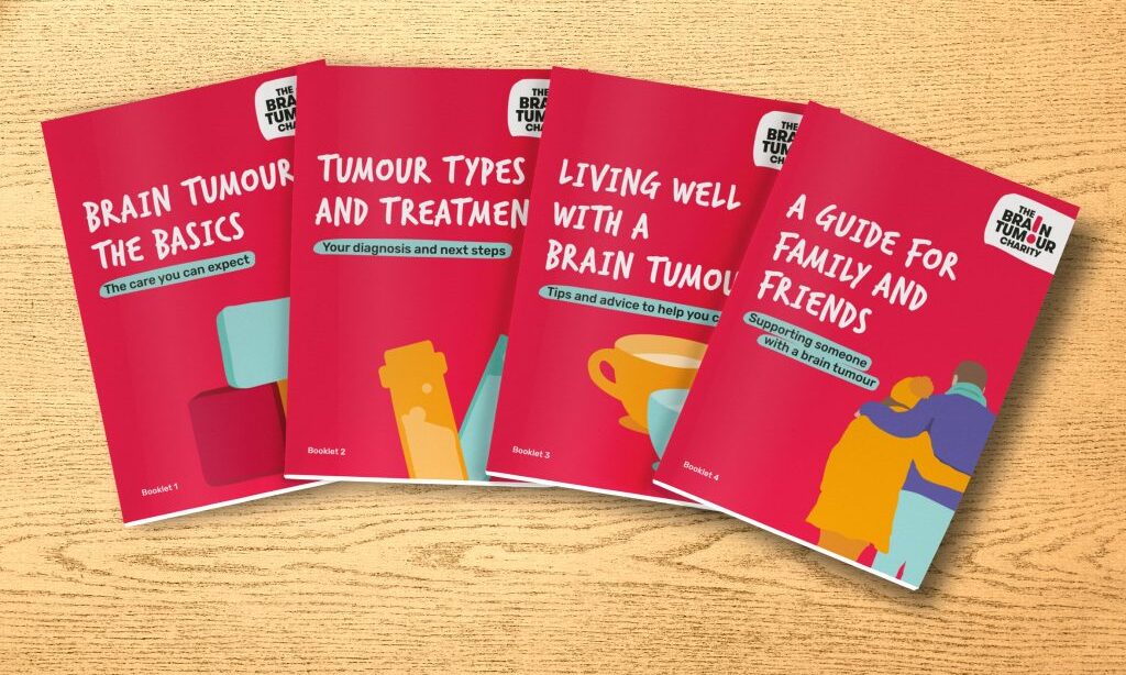 Four booklets from The Brain Tumour Charity information pack spread out on a wooden table