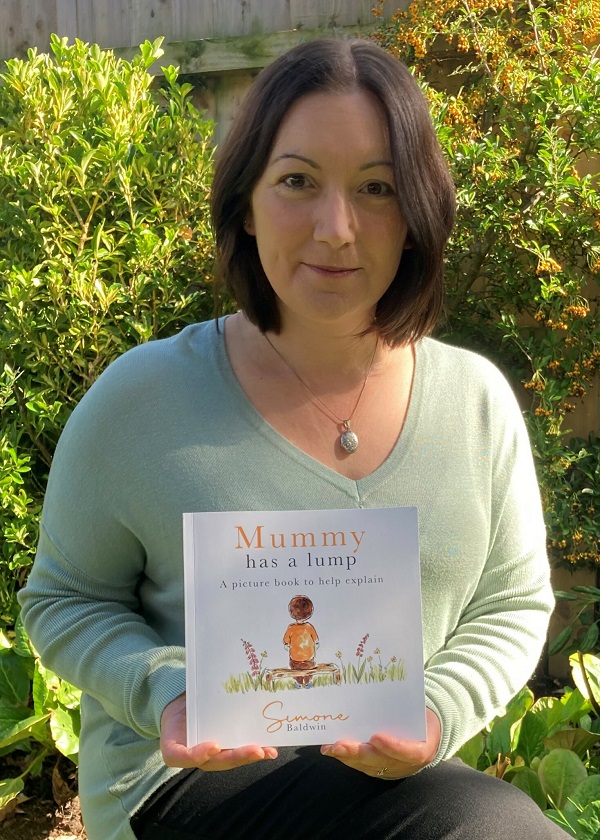 Simone Baldwin holding her new book, Mummy Has a Lump