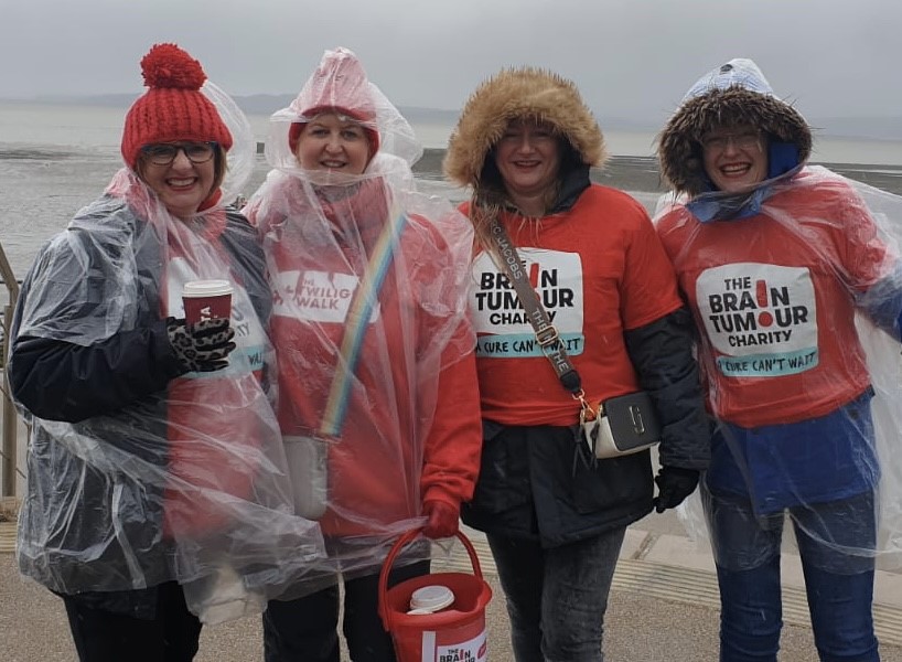 Group of women at the beach in The Brain Tumour charity t-shirts