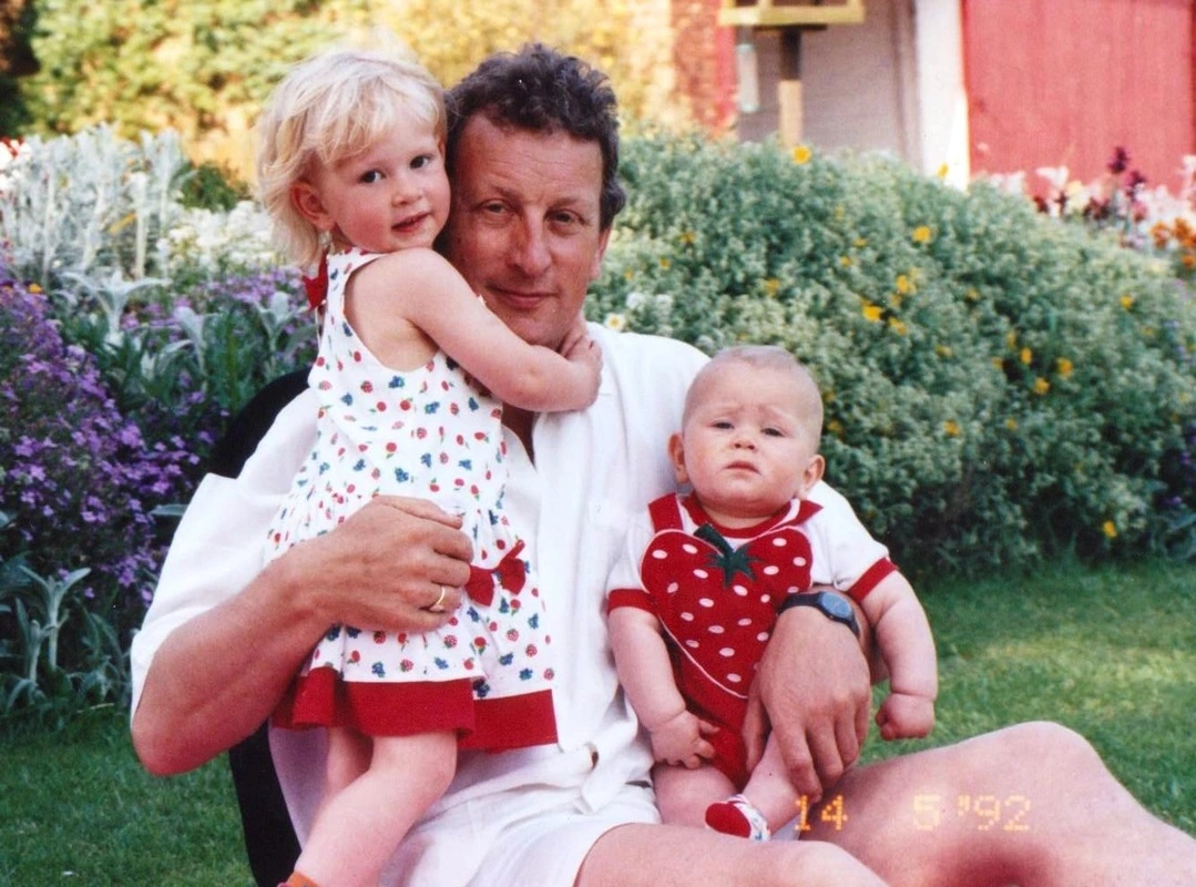 Brian Cross, inspiration for the Brian Cross Memorial Fund, sits with two of his children