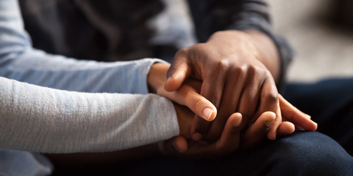 Two people holding hands