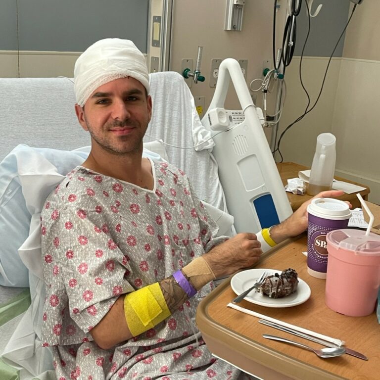 Musician Josh in a hospital bed following surgery for a brain tumour