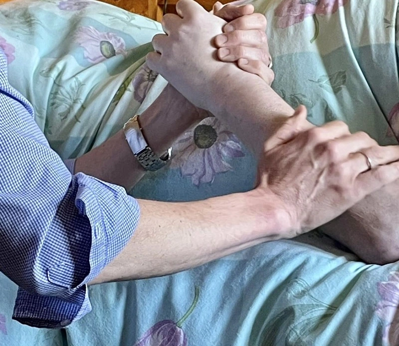 Rob Walker holding Stephen Isles' hand on the day Stephen died. Stephen is one of 4 friends who inspired the Absent Friends Tour