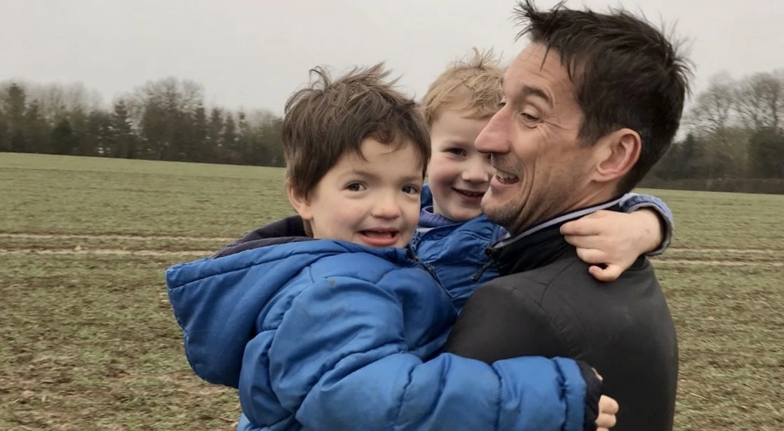 Rob Walker holding George Hawkins - a child who passed away, inspiring Rob's Absent Friends Tour