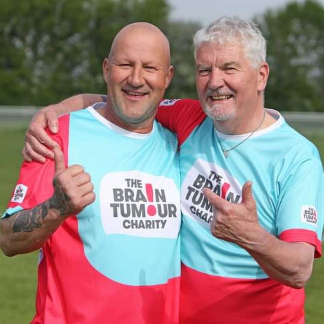 Two football players wearing The Brain Tumour Charity shirts