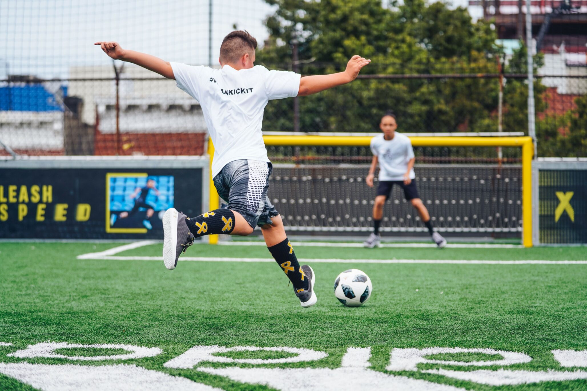 child playing football, going for a goal