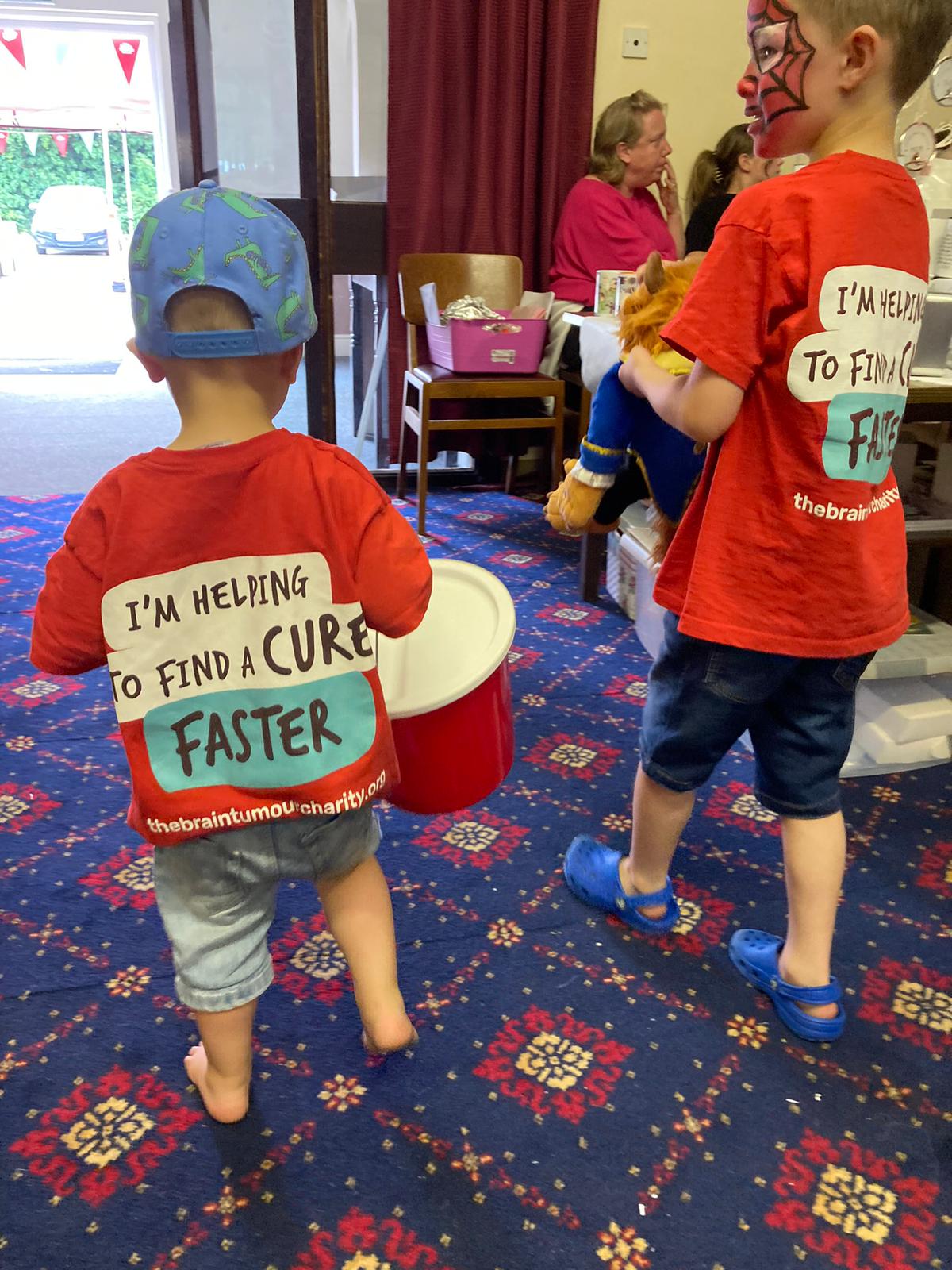 Young boys having their faces painted at a Fun Day arranged by an incredible supporter of The Brain Tumour Charity