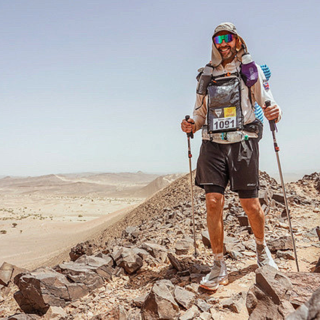 Simon stands on some desert rocks during the Marathon Des Sables