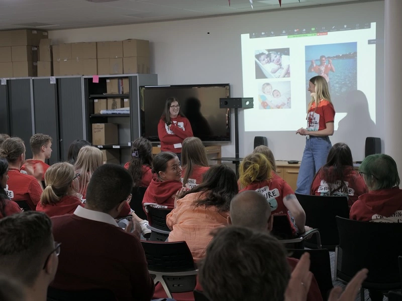 A young woman does a presentation at The Brain Tumour Charity 