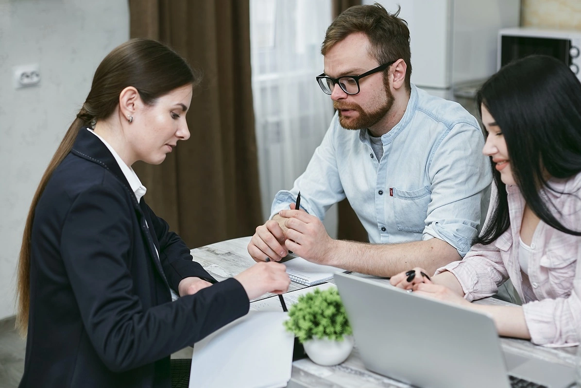 a couple sits with a solicitor discussing how to write a Will for free