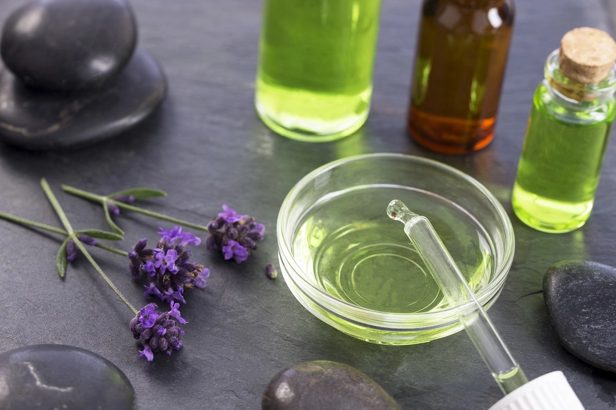 Homeopathic remedies stand on a table with a bowl of liquid and a dropper