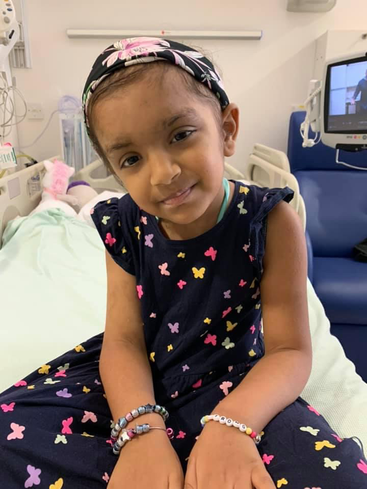 Layla sitting in a hospital bed during treatment for medulloblastoma