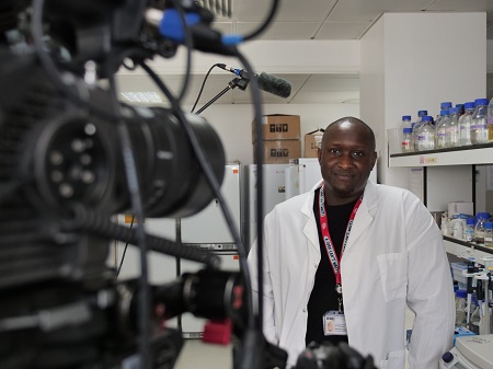 Dr Rominiyi being filmed in his lab