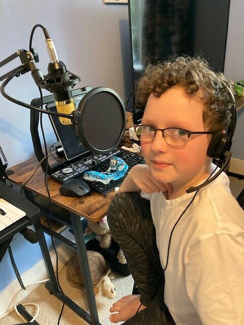 Zac with his DJ kit in his bedroom.