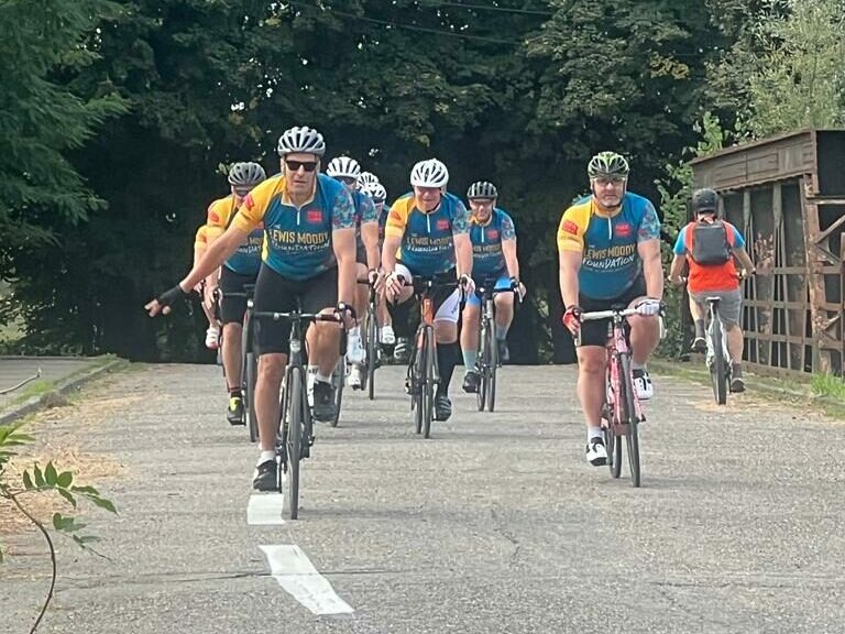 The Lewis Moody Foundation riders cycling along a road as part of their challenge