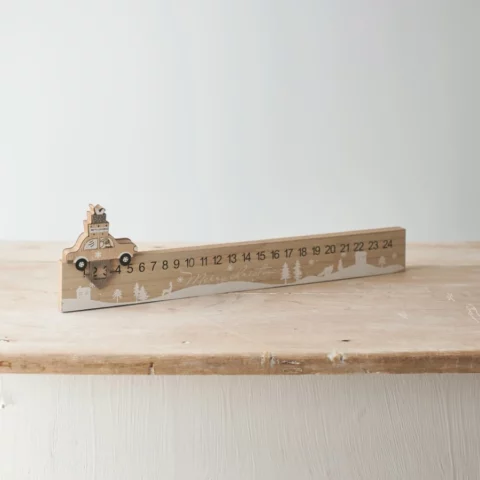 wooden car Christmas countdown calendar on a wooden shelf. Counting down to Christmas is one of the Christmas activities to do at home