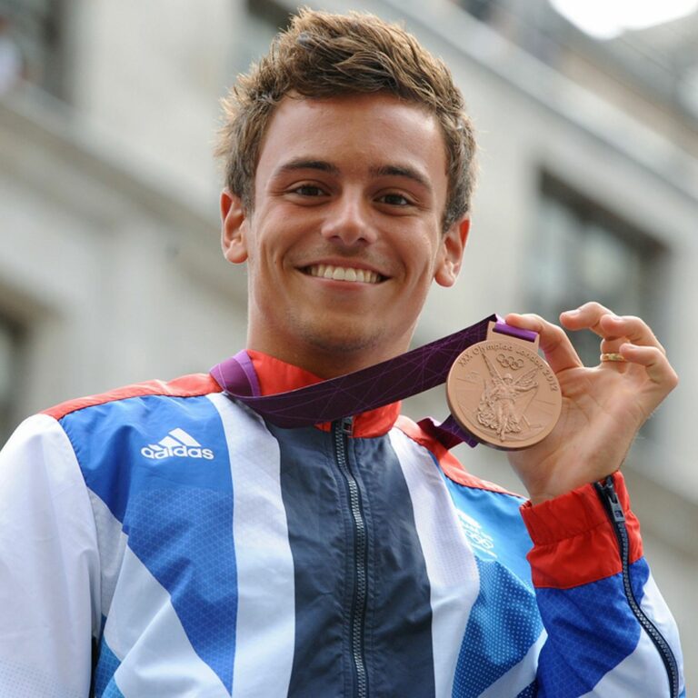 Tom Daley holding an Olympic Medal