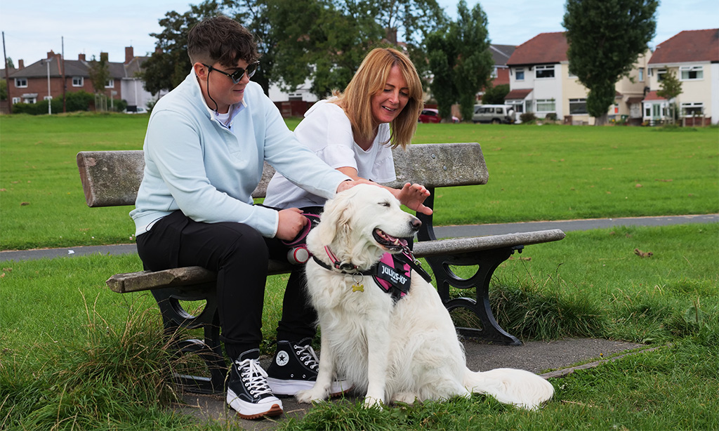 Mel with her mum and their dog in a park