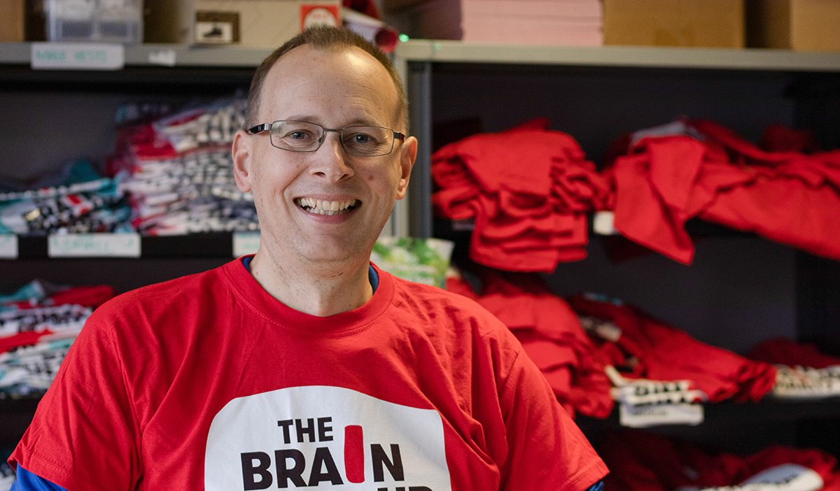 Volunteer Oliver Highway, smiling and standing in front of Brain Tumour Charity