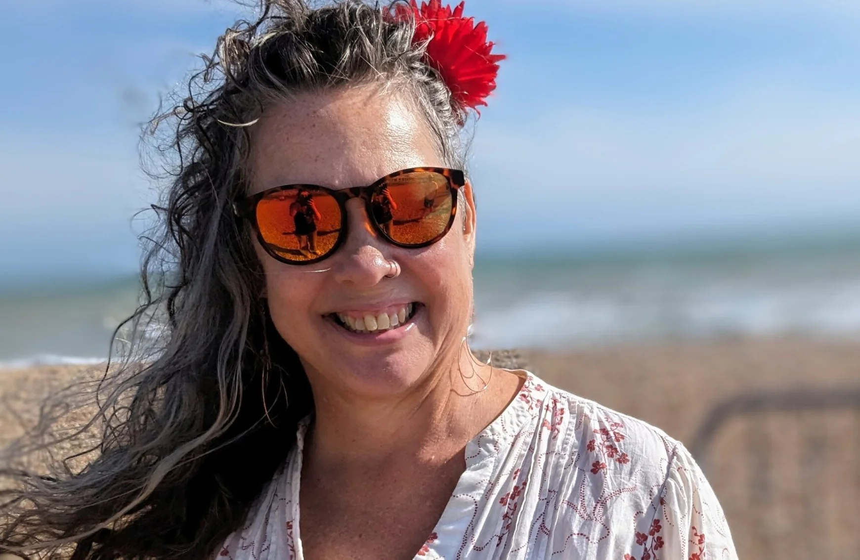 Helen Nelder Chowney smiles on the beach. She's taking on a triathlon for her 60th birthday.