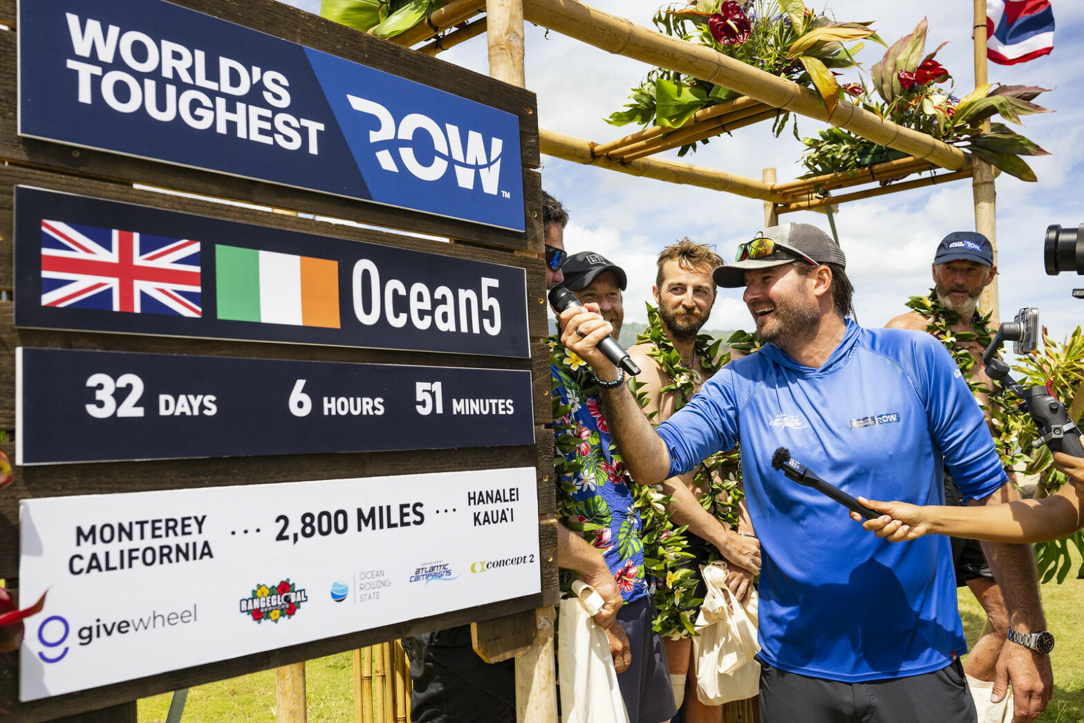 It's official! The crew standing next to a poster of the world record time.