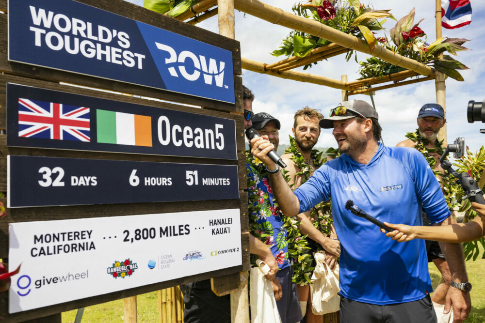 It's official! The crew standing next to a poster of the world record time.
