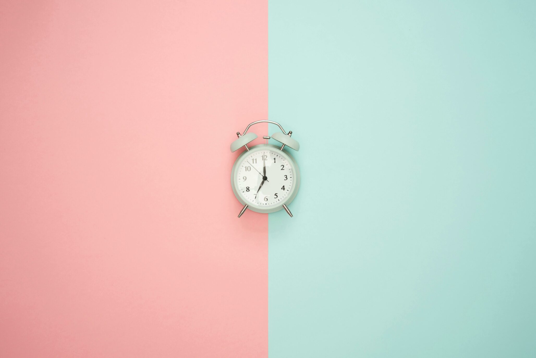 Alarm clock on green and red background