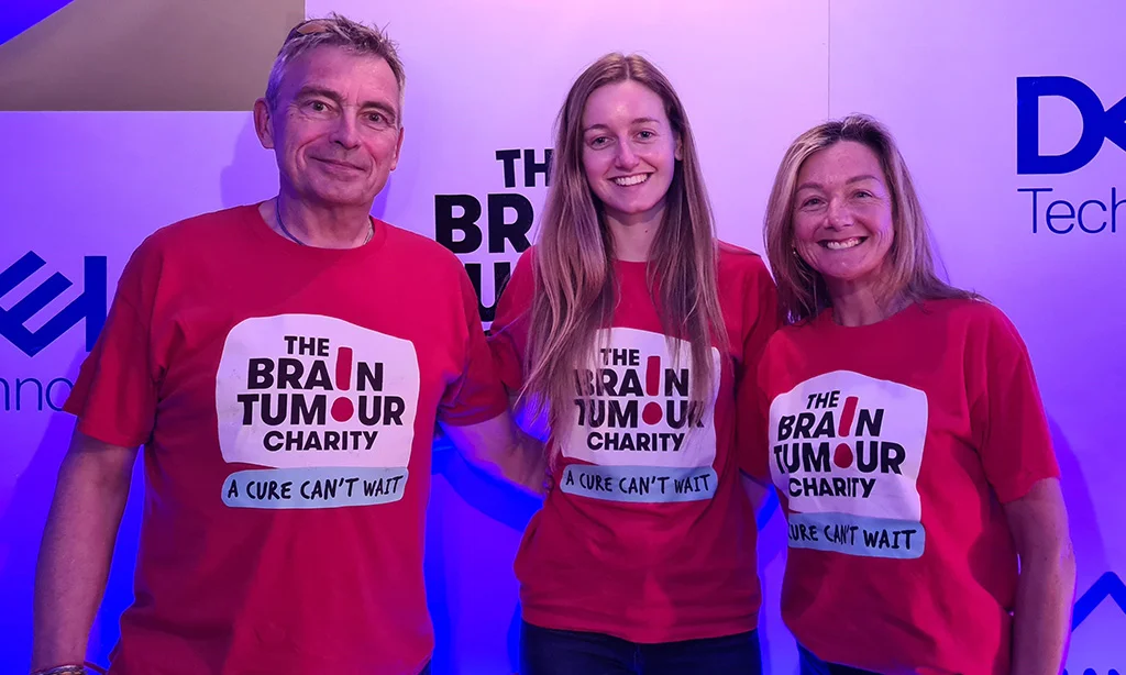 A group of individuals wear The Brain Tumour Charity t-shirts at a corporate event
