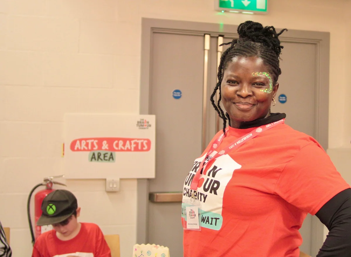 A volunteer stands at the arts and crafts area of The Twilight Walk