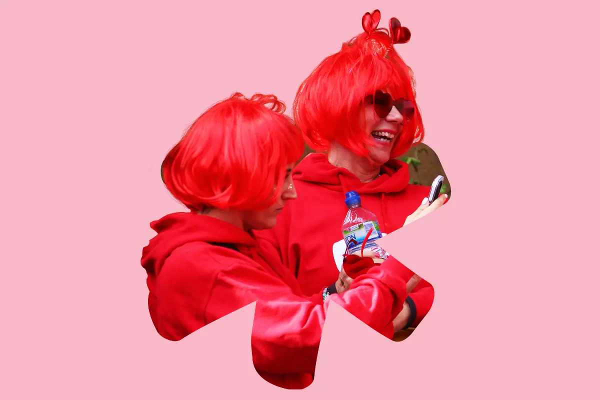 Two people wear red wigs and red clothes for Wear It Red on 5 December