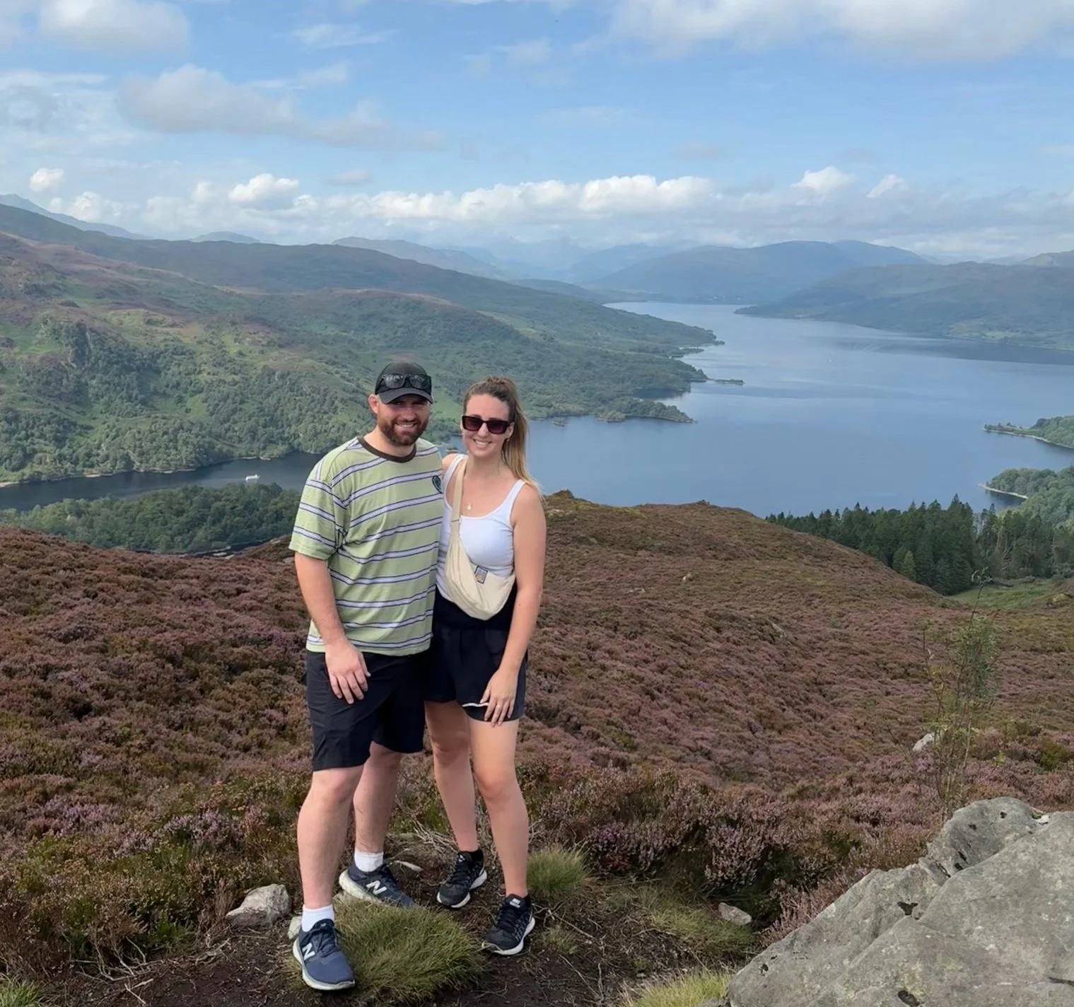 Megan and Dave stand on a hill overlooking water