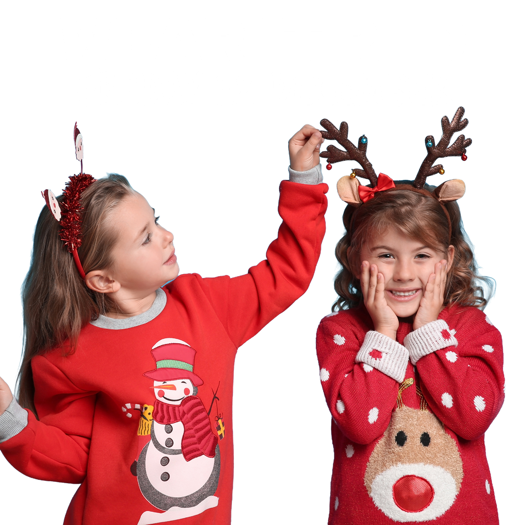 Two young girls wearing red Christmas jumpers for The Brain Tumour Charity's Wear it Red fundraising day in December