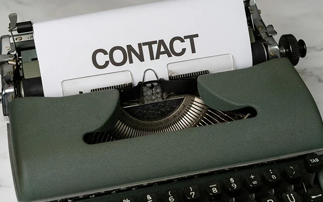 Typewriter with contact written on the page