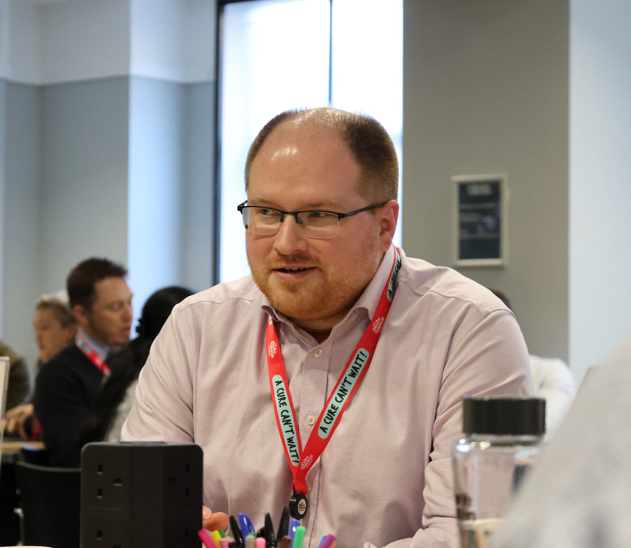 Dr Chris Mount sits at a table